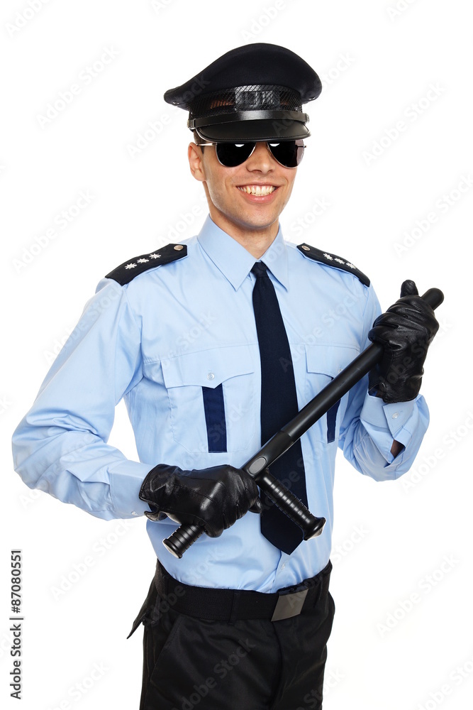 Smiling young policeman in sunglasses holding nightstick