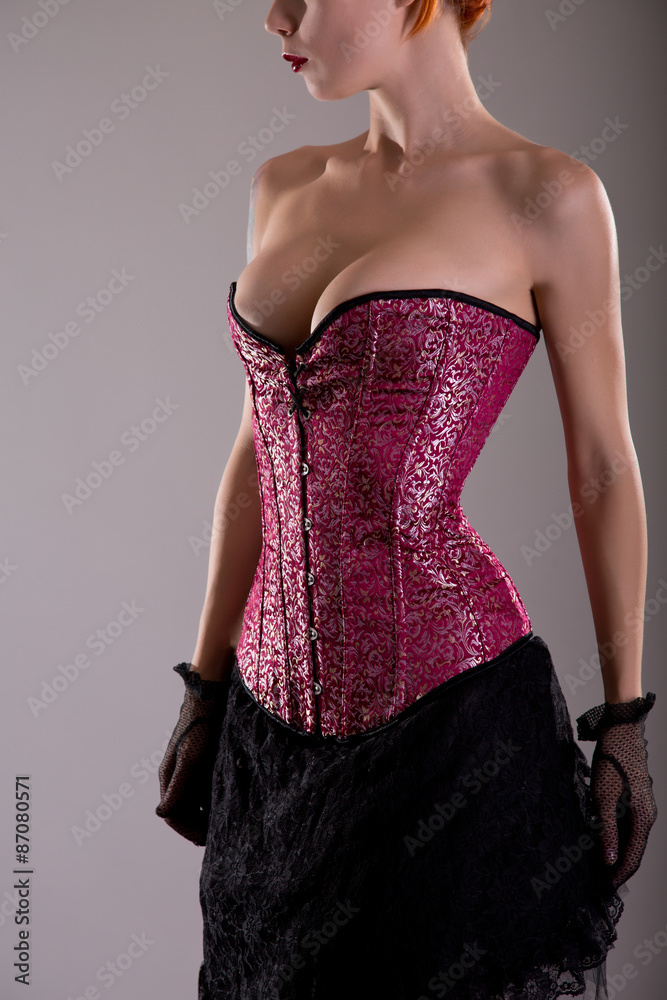 Busty young woman in purple corset Stock Photo | Adobe Stock