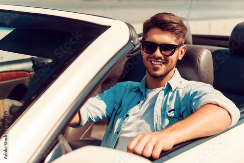 He loves his convertible.  © gstockstudio