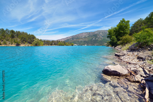 Smooth turquoise water of Lake Sainte-Croix-du-Verdon against th
