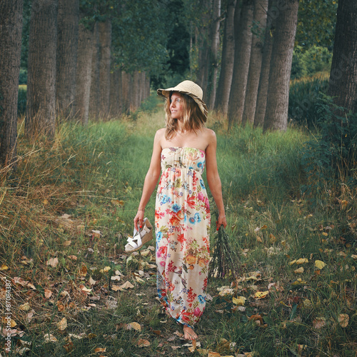 Beautiful woman walking barefooted in nature
