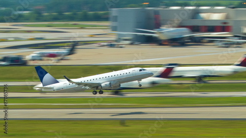 Generic Embraer Jet Commercial Airliner Taking Off from the Worlds Busiest Airport ATL into a Clear Blue Sky on a Sunny Day in Atlanta.