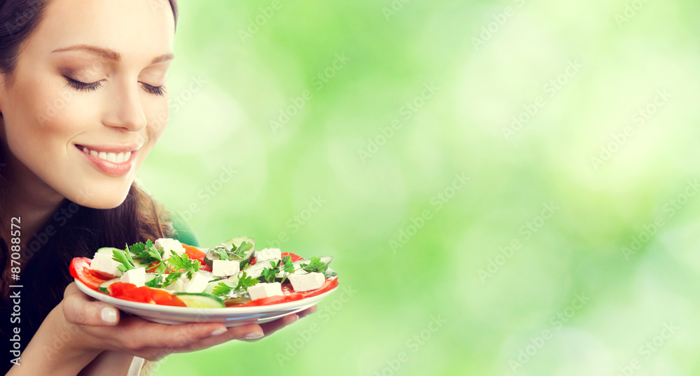 Young brunette woman with plate of salad Young brunette woman with plate of salad