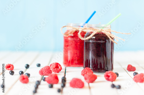 Rustic Mason Jars with raspberry jam and bog bilberry marmalade photo