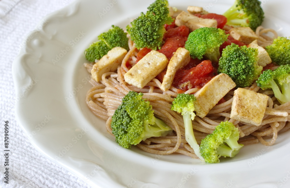 whole grain spaghetti with vegetable - broccoli, tomato and tofu whole grain spaghetti with vegetable - broccoli, tomato and tofu