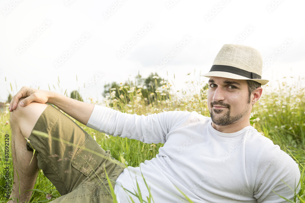 Happy young man in a field