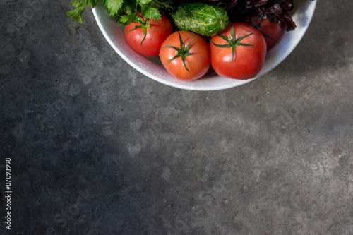 Freshly harvested organic vegetables on a gray background
