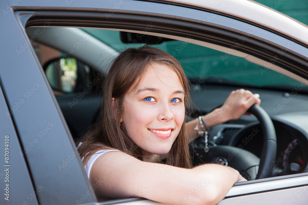 Teenage girl drives in a car