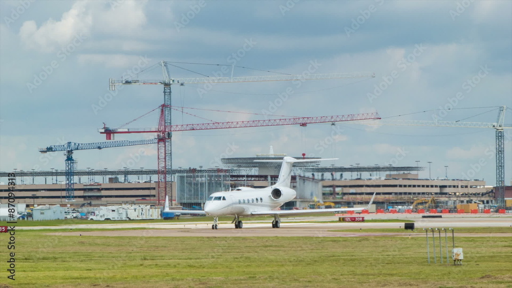 Unmarked Executive Business Jet Airplane at Airport Clean White Plane with No Markings with Expansion Construction in the Background Unmarked Executive Business Jet Airplane at Airport Clean White Plane with No Markings with Expansion Construction in the Background