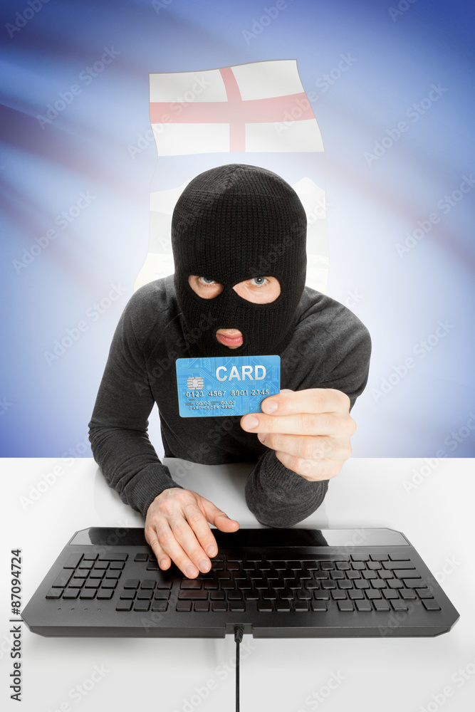 Hacker with credit card in hand and Canadian province flag on background - Alberta Hacker with credit card in hand and Canadian province flag on background - Alberta