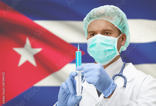 Canvas Print Doctor with syringe in hands and flag on background series - Cuba