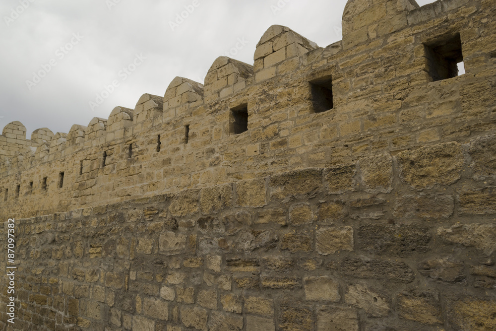 Stone fortress wall with grey sky background