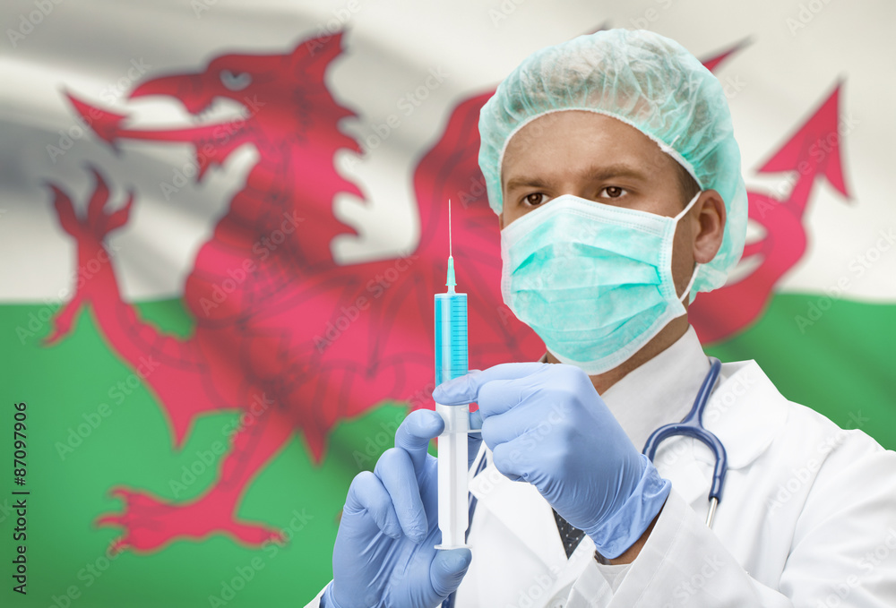 Doctor with syringe in hands and flag on background series - Wales Doctor with syringe in hands and flag on background series - Wales