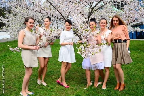 Girls with champagne celebrating in sakura's garden.