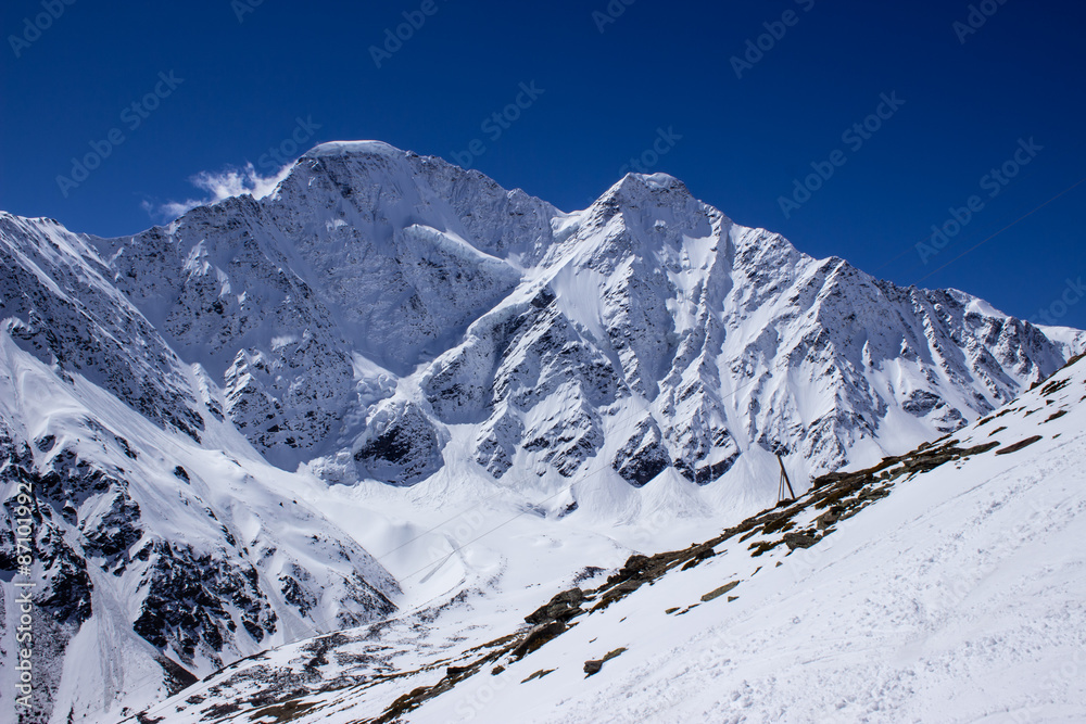 snow slope with rocks in the background the peak of 