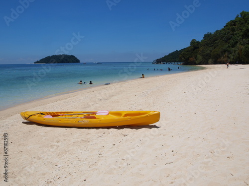 yellow canoe on the beach