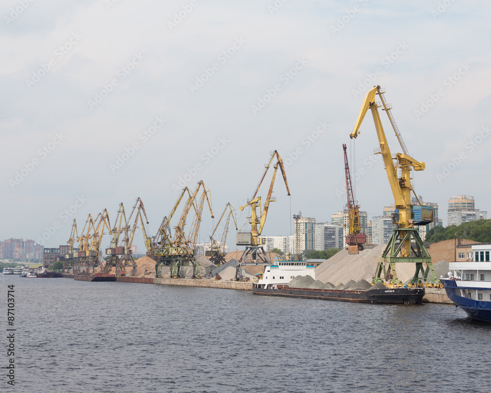 Port cranes loaded barges