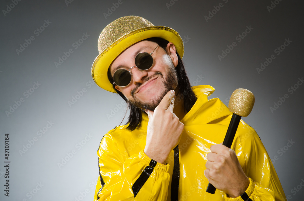 Man wearing yellow suit with mic Man wearing yellow suit with mic