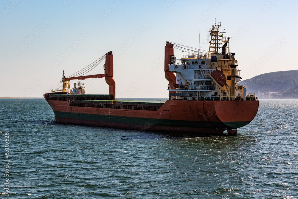 Fototapeta premium Cargo Ship Sailing in Ocean