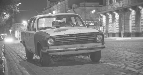 Old car on a street at night