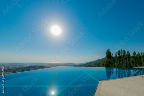 Infinity pool on the bright summer day