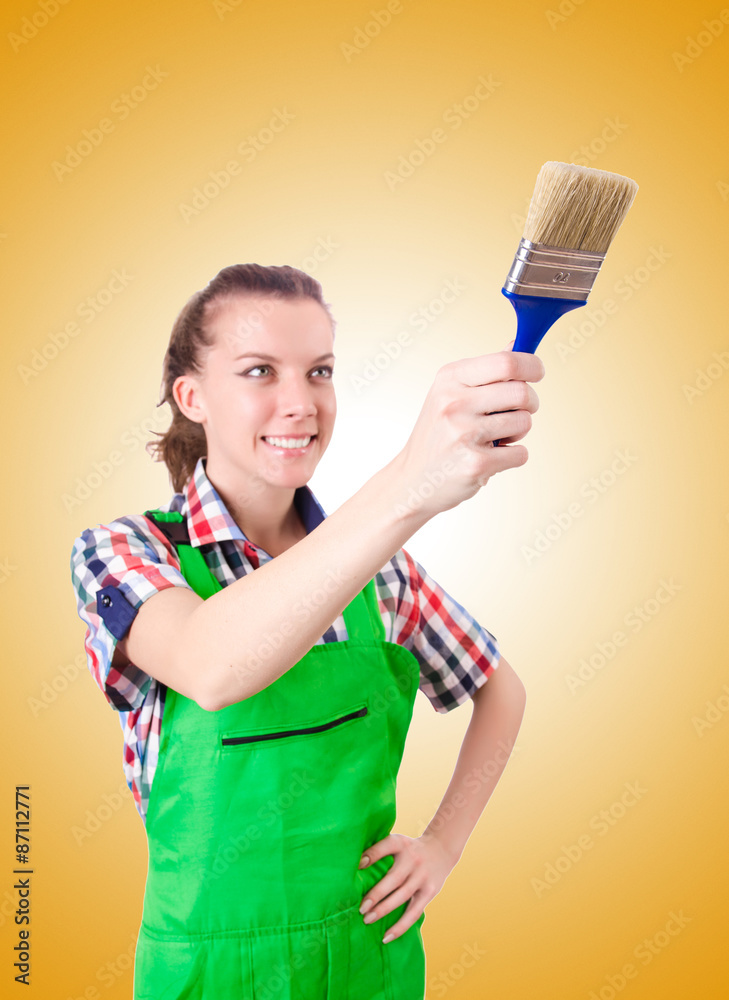 Woman painter with paintbrush against gradient Woman painter with paintbrush against gradient
