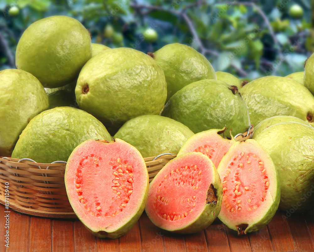 Some brazilian guavas over a striped surface.