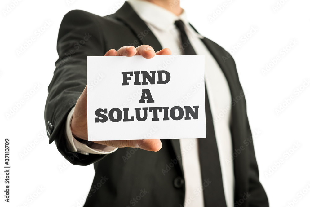 Business executive in a suit holding up a business card saying - Business executive in a suit holding up a business card saying -