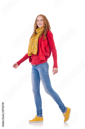 Cute smiling girl in red jacket and jeans isolated on white