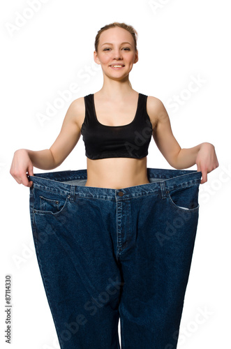 Dieting concept with big jeans on white