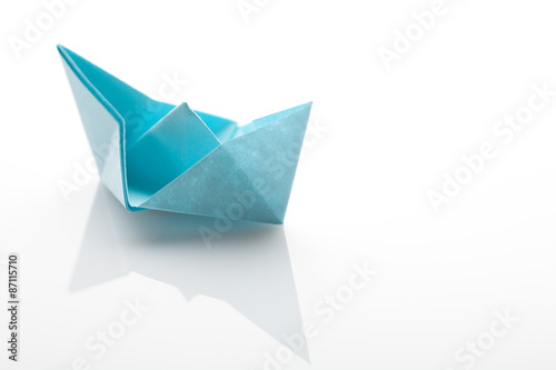 Origami paper ship on white background
