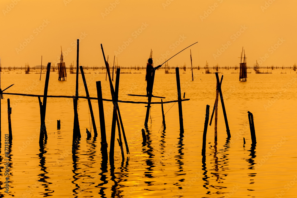 silhouette of fishermen with fishing in the lake. silhouette of fishermen with fishing in the lake.