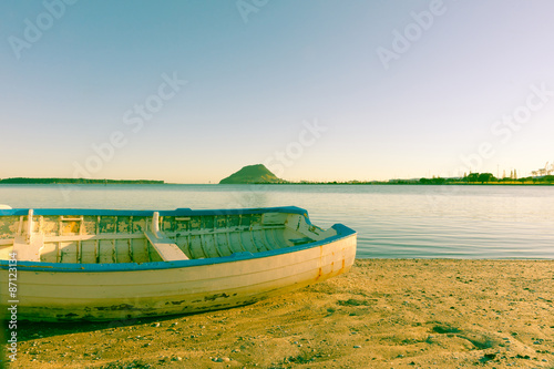 Old style image clinker dinghy on beach