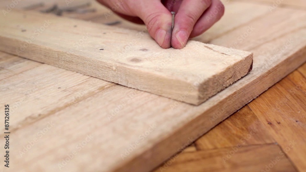 Carpenter hitting nails using hammer, joining wood planks, close up; hd 1080 Carpenter hitting nails using hammer, joining wood planks, close up; hd 1080