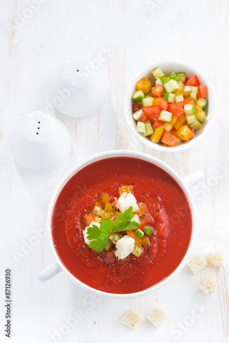 gazpacho with croutons and vegetables in a bowl, top view