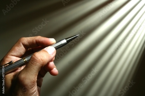 Hand holding a pen