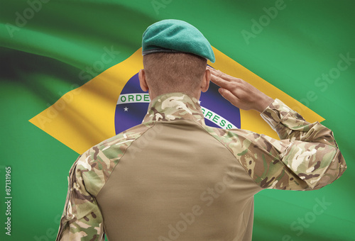 Obraz na płótnie Dark-skinned soldier with flag on background - Brazil w salonie