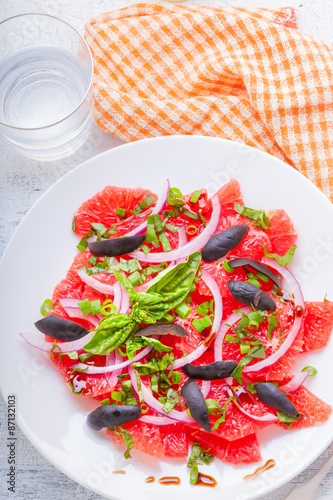 Grapefruit salad with olives, red onion, basil