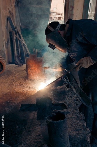 Welding steel. Welder worker works.