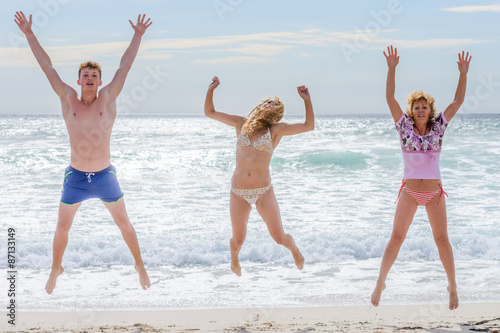 young men jumping on the background of the sea