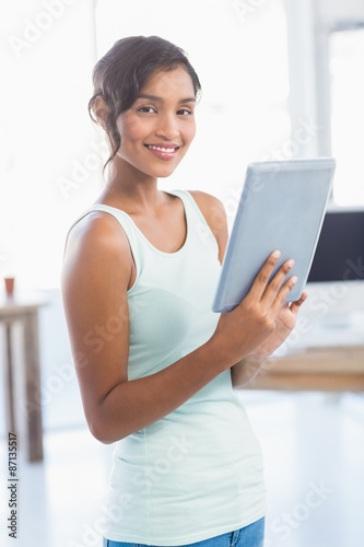 Casual brunette showing tablet computer Free Download Casual brunette showing tablet computer - GFXLoad