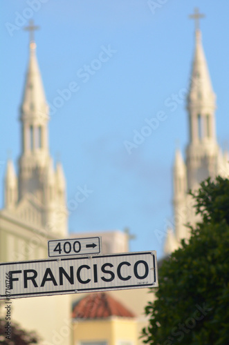 Francisco street sign against the bells towers of Saints Peter a photo