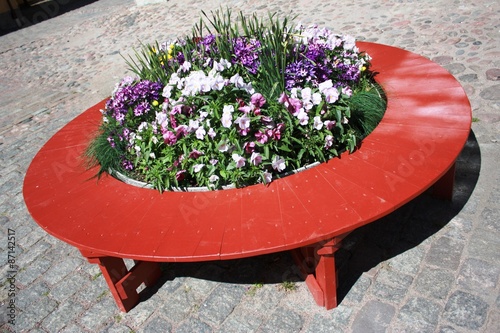 Bench with flowers in the courtyard of the Kronhuset in Gothenburg Sweden photo