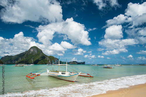Seaview with the pump boat under cloudy sky in El Nido beach. Palawan, Philippines.