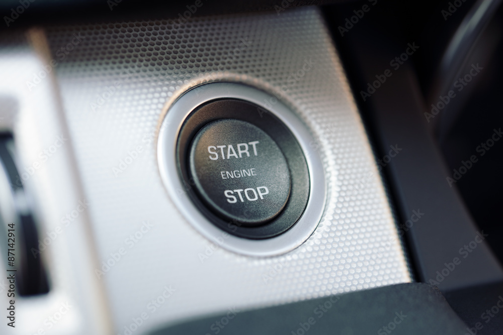 Car engine start and stop button on a hybrid electric car