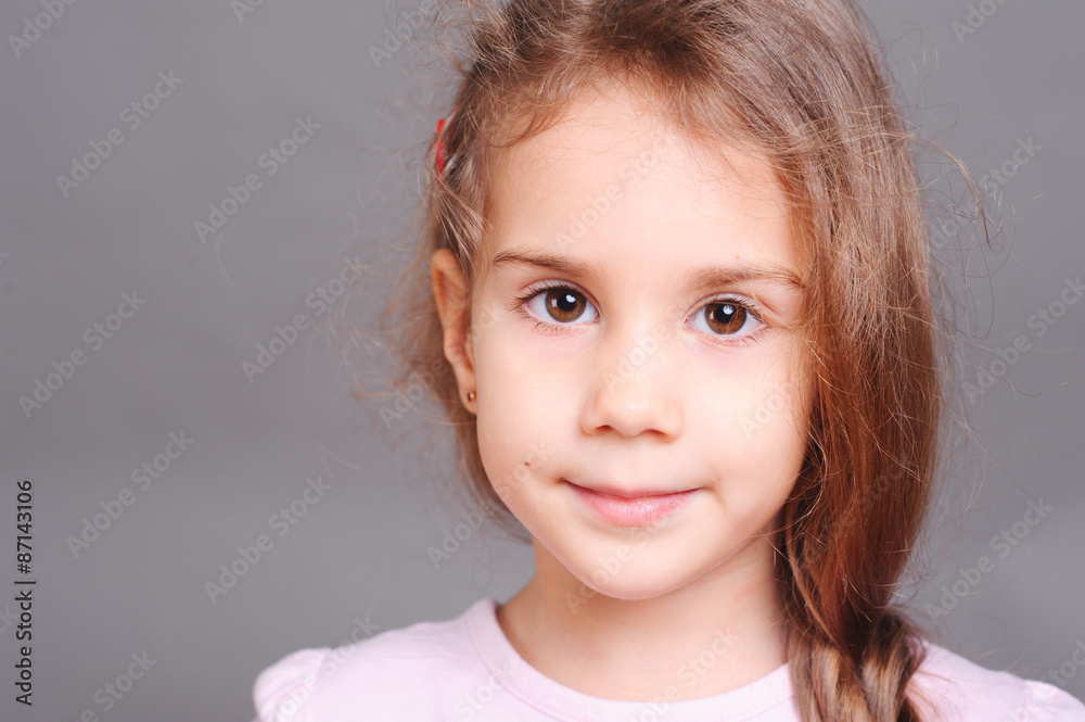 Close up portrait of cute little girl in studio at gray background Close up portrait of cute little girl in studio at gray background