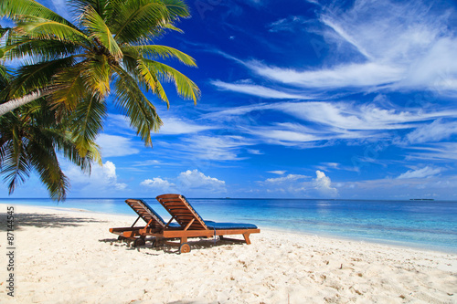 Fototapeta Naklejka Na Ścianę i Meble -  Two chairs on the tropical beach