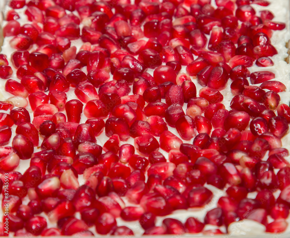 Pomegranate red seeds background in salad Pomegranate red seeds background in salad