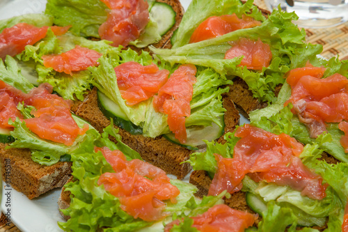 Sandwiches with salmon, lettuce and cucumber