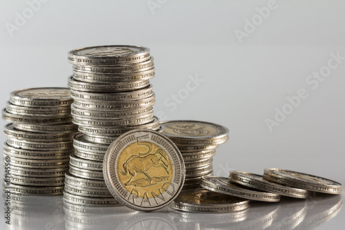 silver coins piled on white background photo